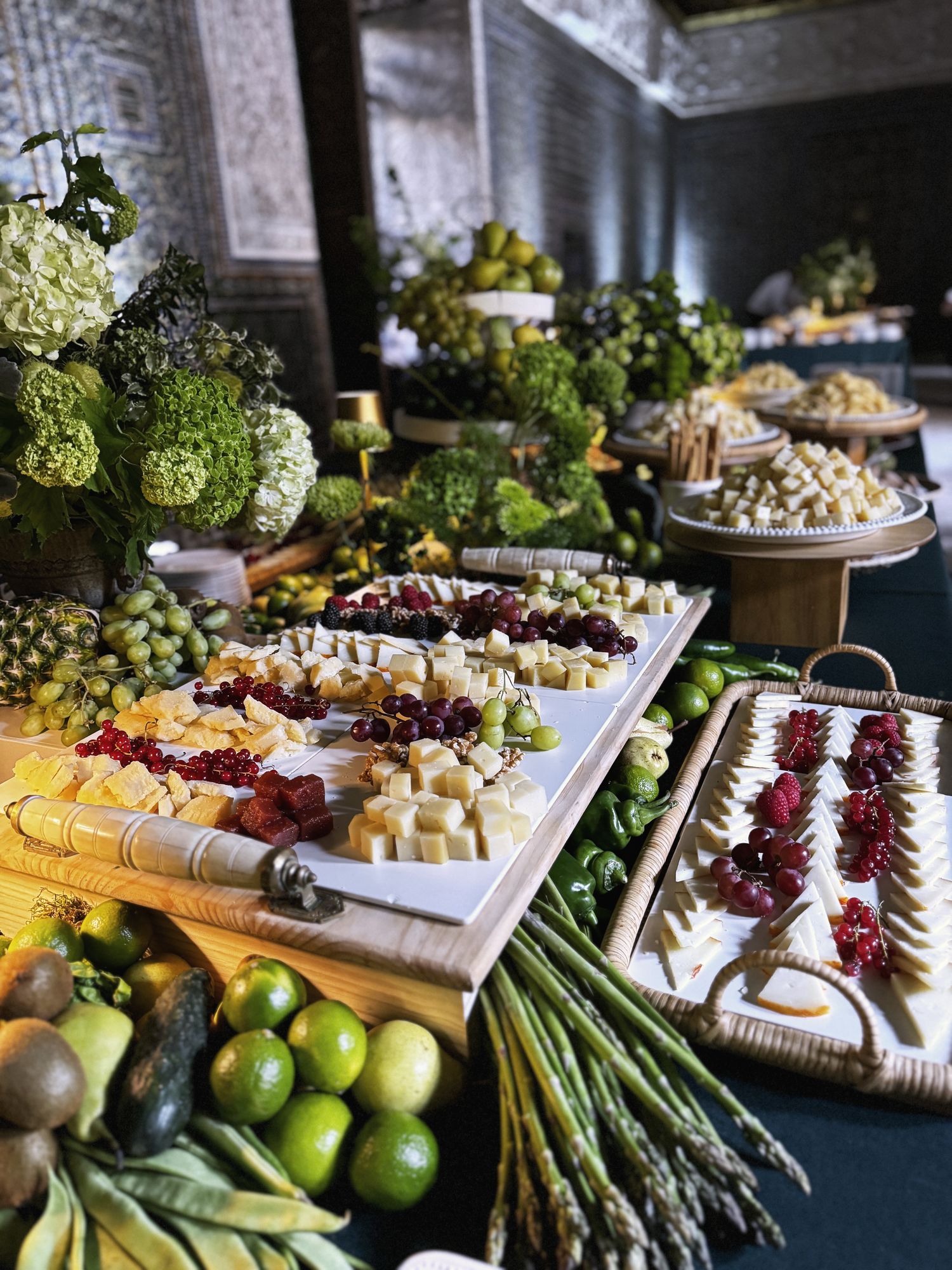 Grand produce table with vegetables and cheeses