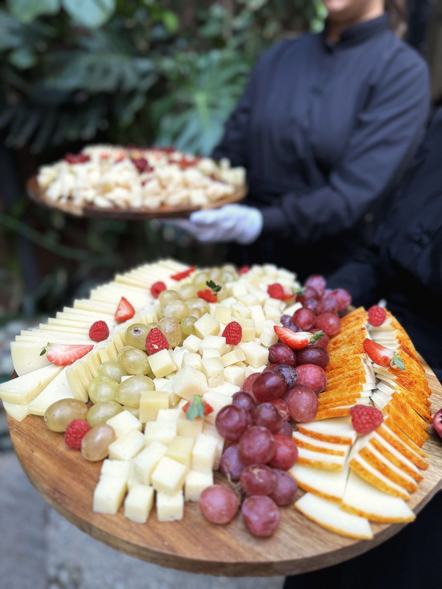 Cheese and fruit board served to guests