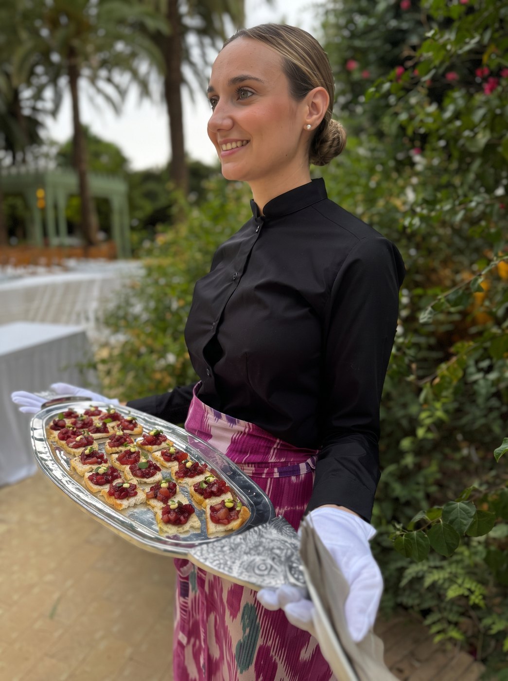 Waitress serving tartare canapés on a silver tray