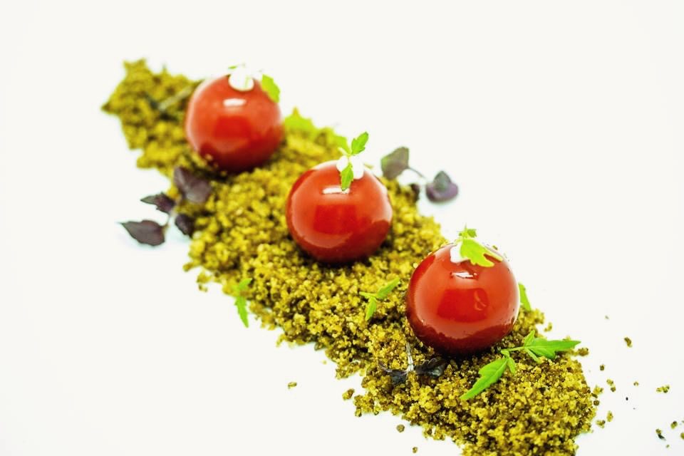 Red spheres on a herb crumble